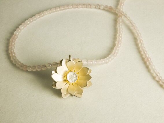 Sterling silver lotus with gold stamen on Rose Quartz beads.