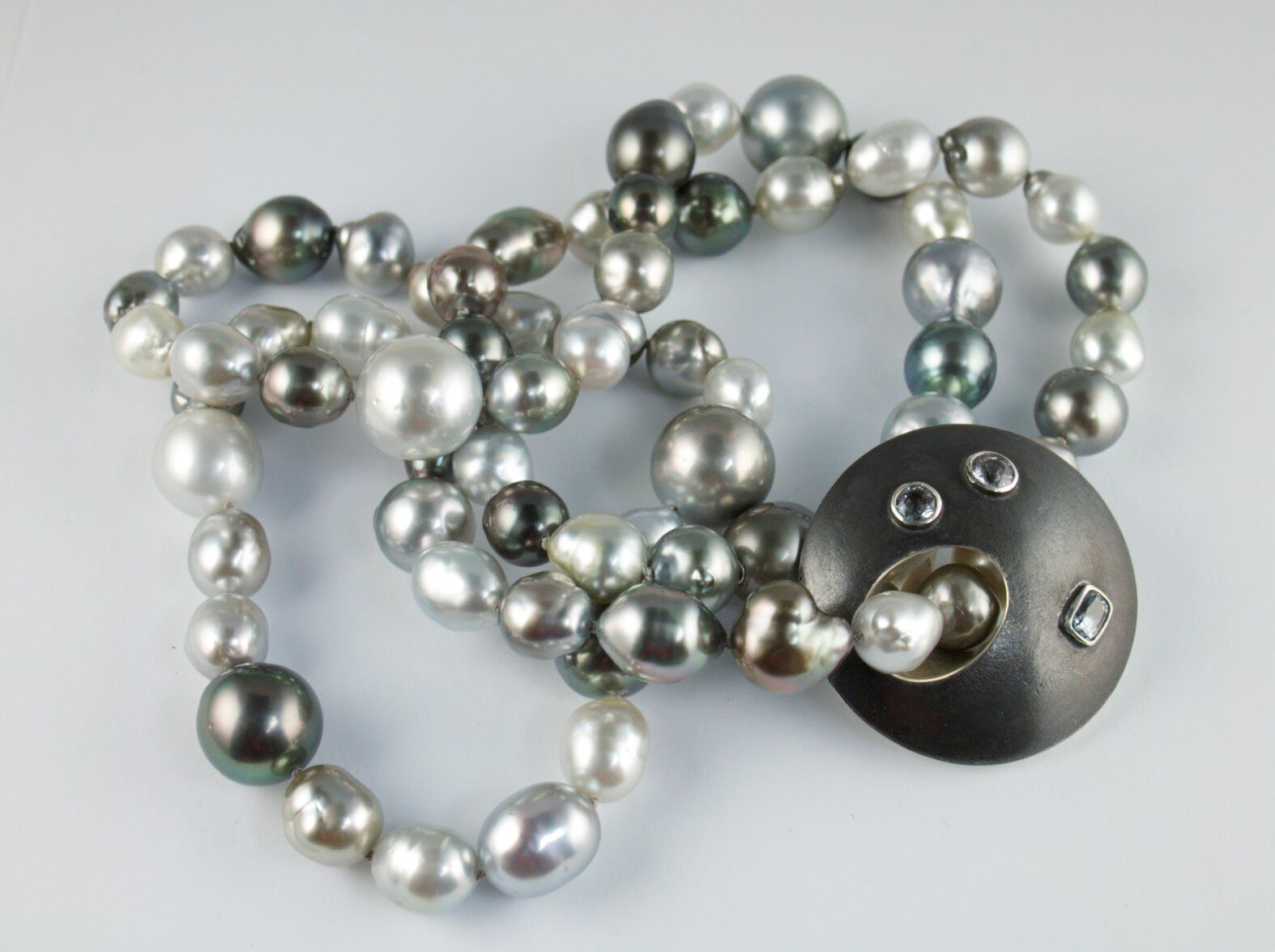 Pearls with silver and sapphire disc