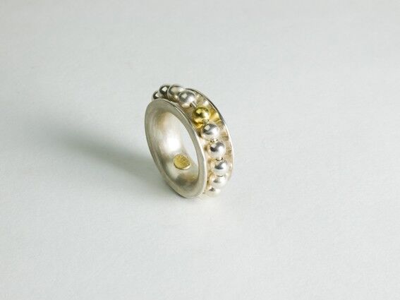  Sterling silver ring with moving beads and 1 gold bead as the counter.