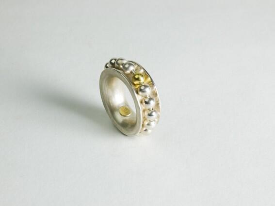 Sterling silver ring with moving beads and 1 gold bead as the counter.