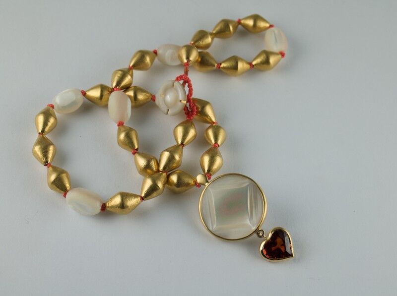 Carved mother of Pearl and 22ct beads with Spessartite garnet heart