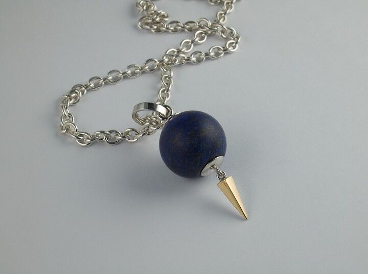 Lapis lazuli bead hollowed out to hold a poem or memento with gold spike