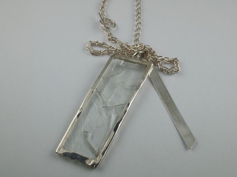 Hiddenite crystal with silver poem