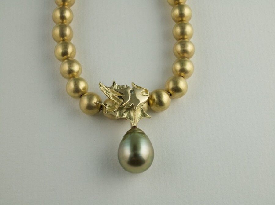 18ct gold beads and carved gold dragon with green Pearl and Sapphire eye