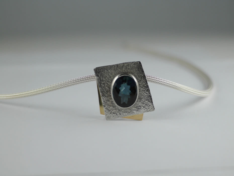 Blue Topaz in 18ct Gold and Sterling Silver frame-Silver cable 