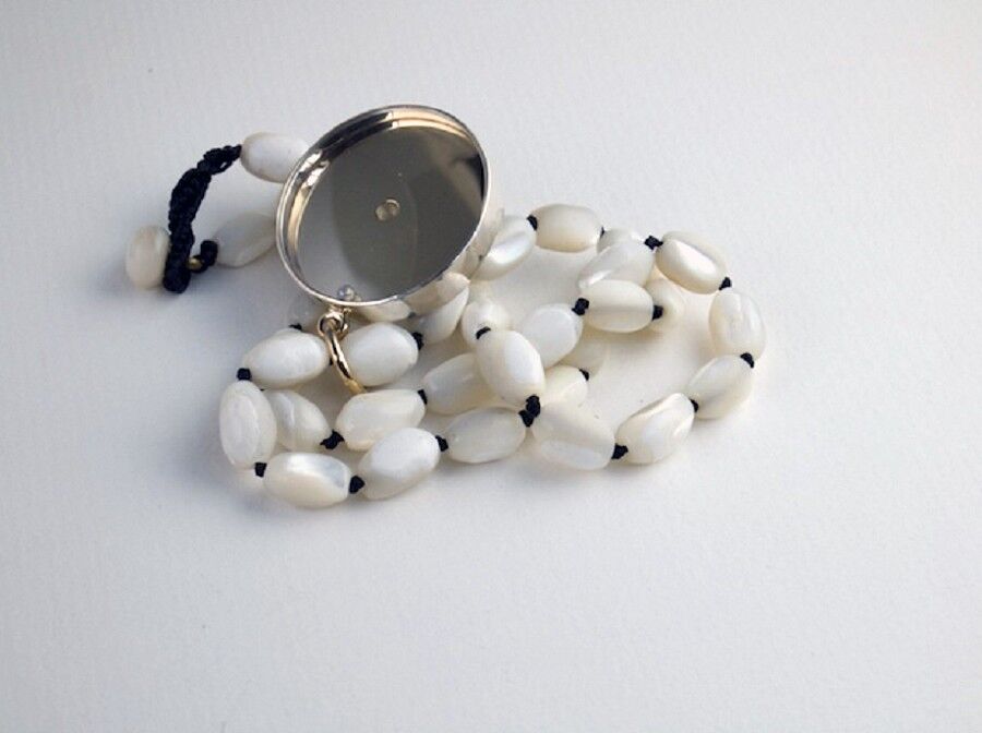 Reverse of necklace with pearl and watch glass